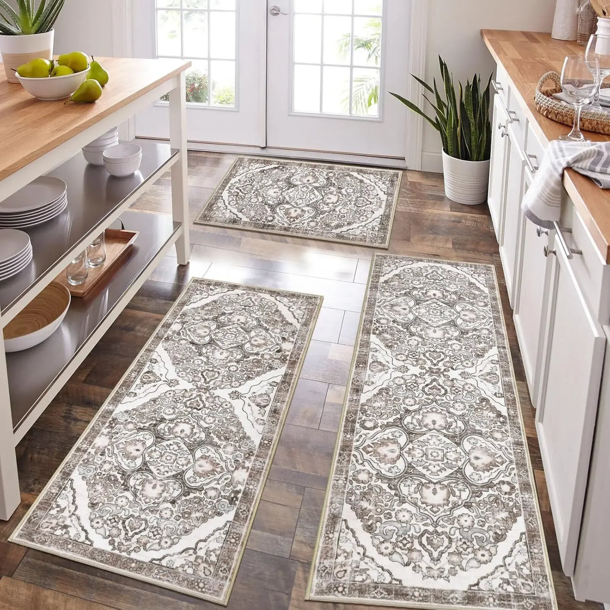 A long rectangular gray and white patterned kitchen rug placed on a wooden floor.