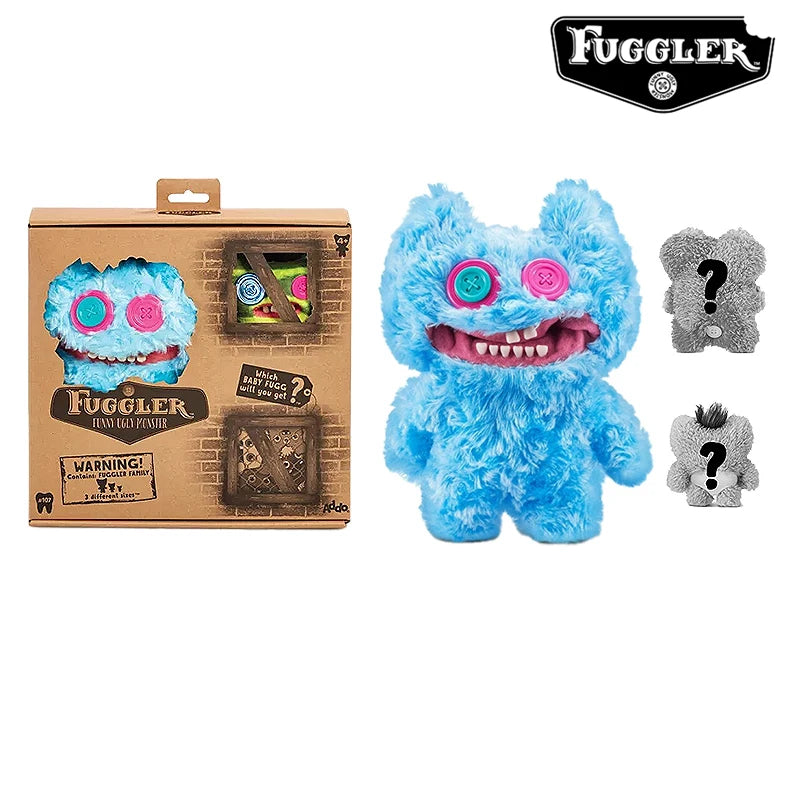 A blue Fuggler ugly monster plush toy with funny teeth and a gray version, packaged in a cardboard box.