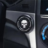 Close-up of a black rotating protective cover for a car ignition start button on a vehicle dashboard.