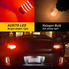 A close-up of a car's taillight featuring an Auxito LED brake light, set against a background showing various light bulbs.