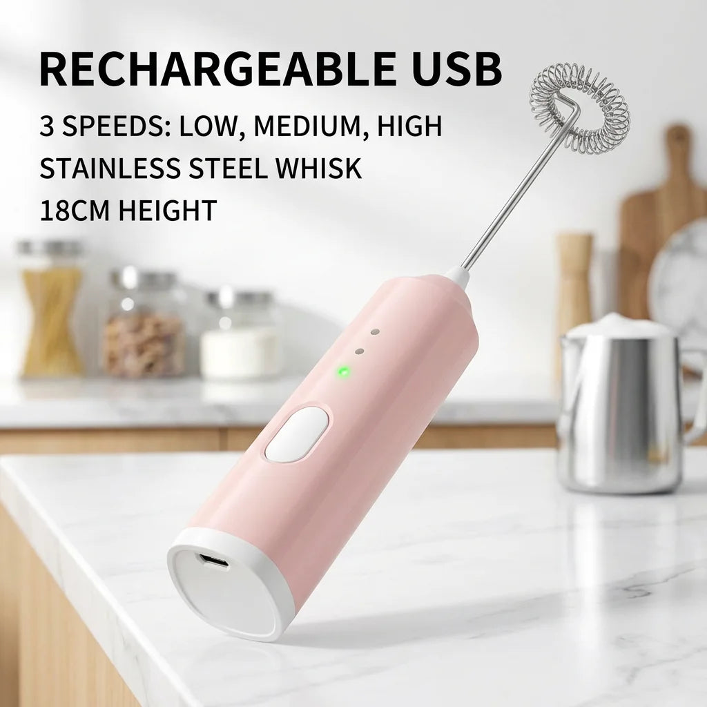 A pink rechargeable USB electric milk frother with a stainless steel whisk on a white countertop.
