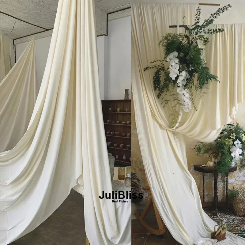 Cream fabric draped in soft folds used as a backdrop or decor