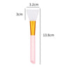 A pink silicone facial mask brush with a white applicator tip and gold handle, shown next to dimension lines.
