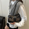 A woman wearing a white blouse and gray vest holds a leopard print PU leather shoulder bag.