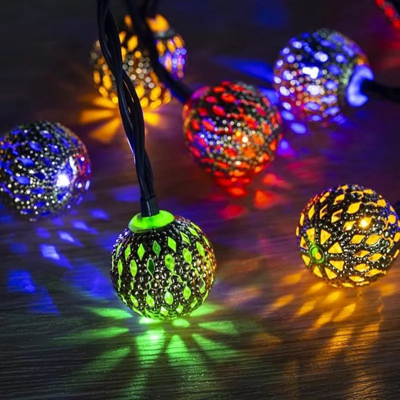 String lights featuring glowing Moroccan-style spherical balls in various colors and modes