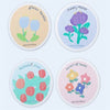 Four circular labels featuring floral designs and Latin phrases for cotton scouring sponges.