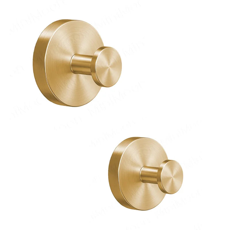 A round, brass-toned towel hook with a cylindrical mounting piece, designed for no-drill wall installation.