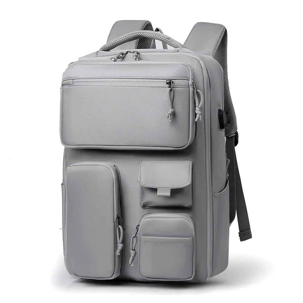 A gray travel backpack with a laptop compartment and multiple storage pockets.