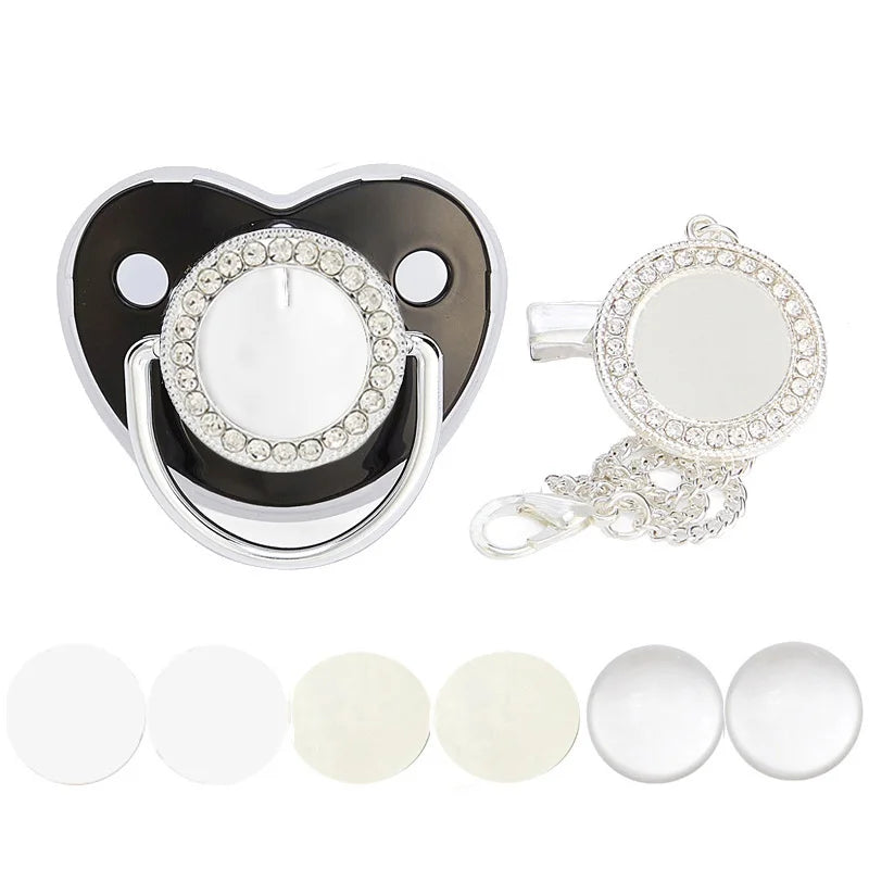 A sparkling rhinestone pacifier with a clip and multiple silicone nipples shown next to the main product.