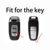 A black Audi key fob cover with a titanium gray leather case, showing the fit for the key.
