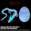 A translucent, articulated dragon figurine with a glowing egg, emitting light in dark environments.