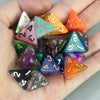 A hand holds a set of ten polyhedral dice in various colors and shapes for tabletop role-playing games