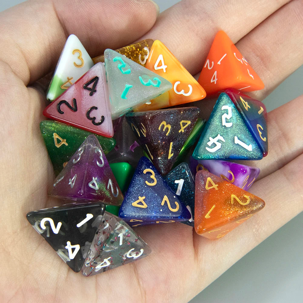 A hand holds a set of ten polyhedral dice in various colors and shapes for tabletop role-playing games