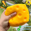 A hand holds a bright yellow cheese-themed squishy stress relief toy with a soft slow rebound.