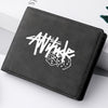 A black leather wallet with white stylized text and dice graphic lying on a white surface.