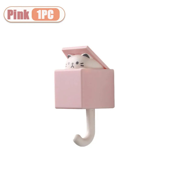 Pink wall hook shaped like a sleeping cartoon cat
