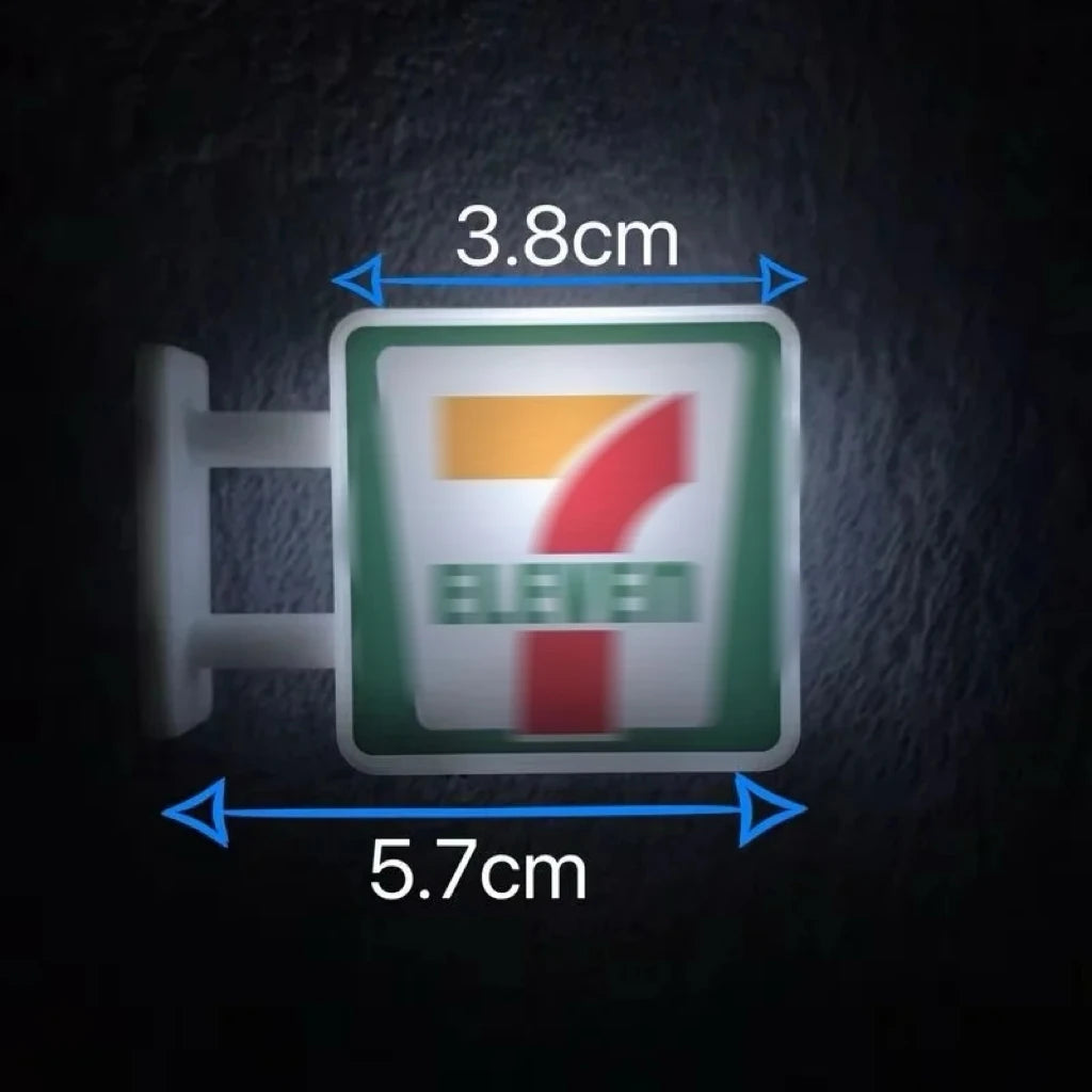 A rectangular fridge magnet featuring the number seven in red and orange on a green background with the word ELEVEN.