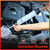 A hand is using an extraction fill pump to draw fluid from a vehicle engine component.