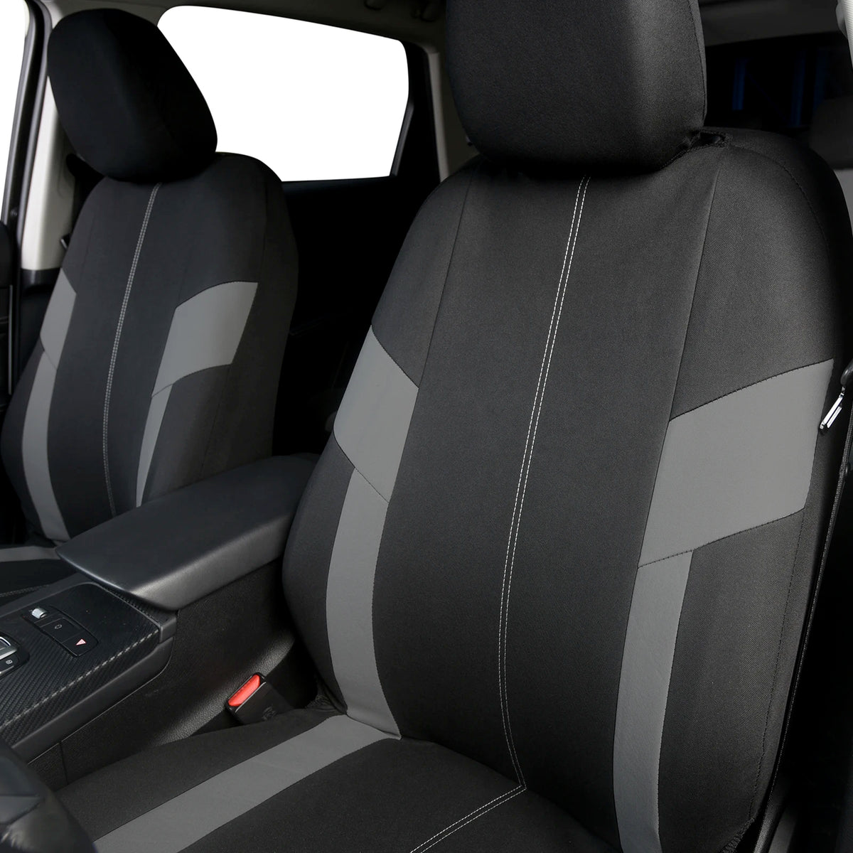 A close-up view of a black car seat cover featuring gray accents and stitching.