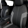 A close-up view of a black car seat cover featuring gray accents and stitching.