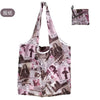 A reusable nylon shopping tote bag featuring a collage print of magazine pages and text.