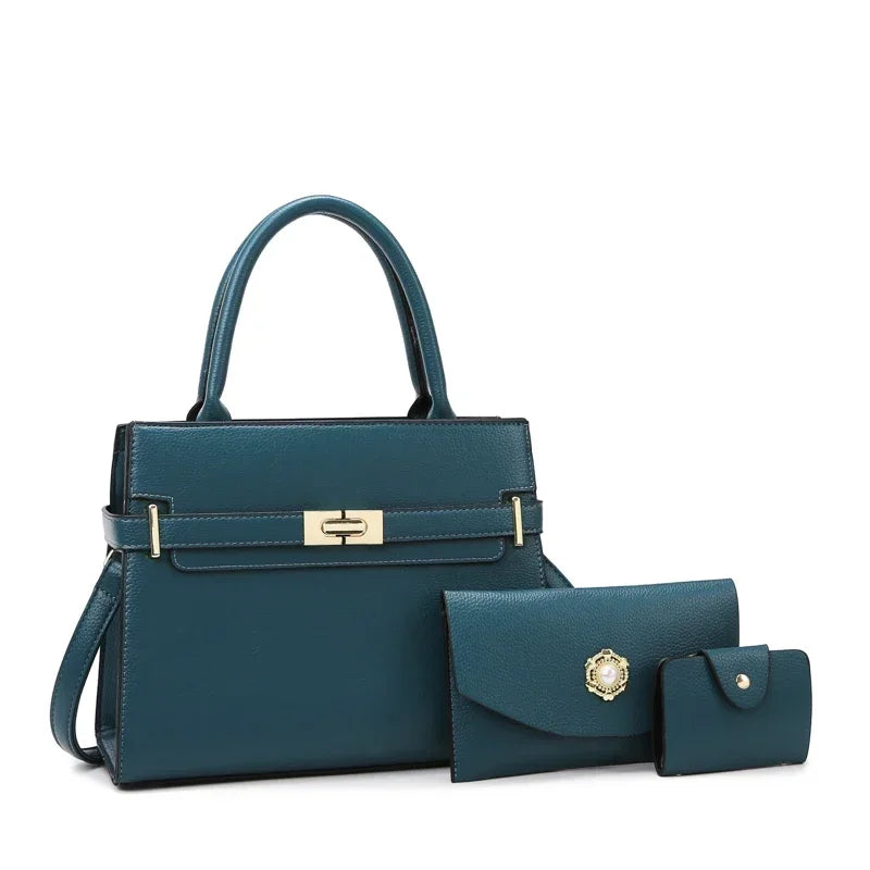 A dark teal leather handbag with gold hardware and a matching coin purse.