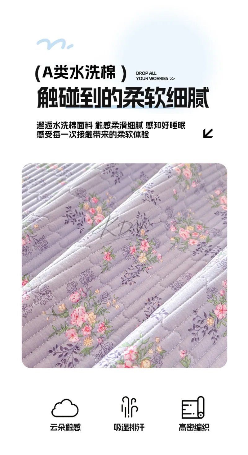 Close-up of a light purple floral quilted bedspread with a textured surface.