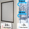 A framed window featuring a patterned film for winter insulation and draft blocking, shown next to temperature gauges.