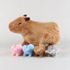 A large brown stuffed animal resembling a cow is shown with several smaller, colorful simulation capybara friends.