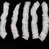 A pack of disposable transparent shower caps arranged in a row.