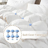 A close-up view of white bedding with six light blue quilt cover fasteners visible on the duvet cover.