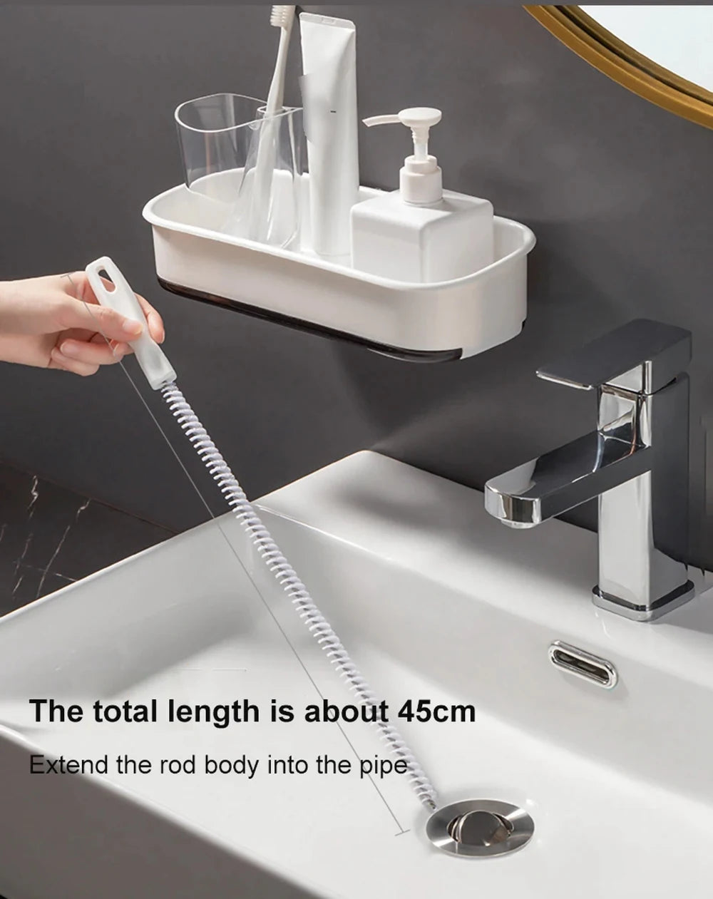 A flexible drain cleaning brush extends about 45cm into a sink pipe.