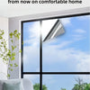 A modern window with a light-colored film installed, showing glare reduction and sun protection.
