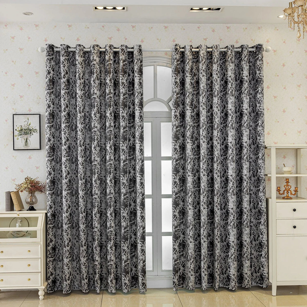 A pair of patterned black and white tree bark jacquard blackout curtain panels hanging in a light-colored room.