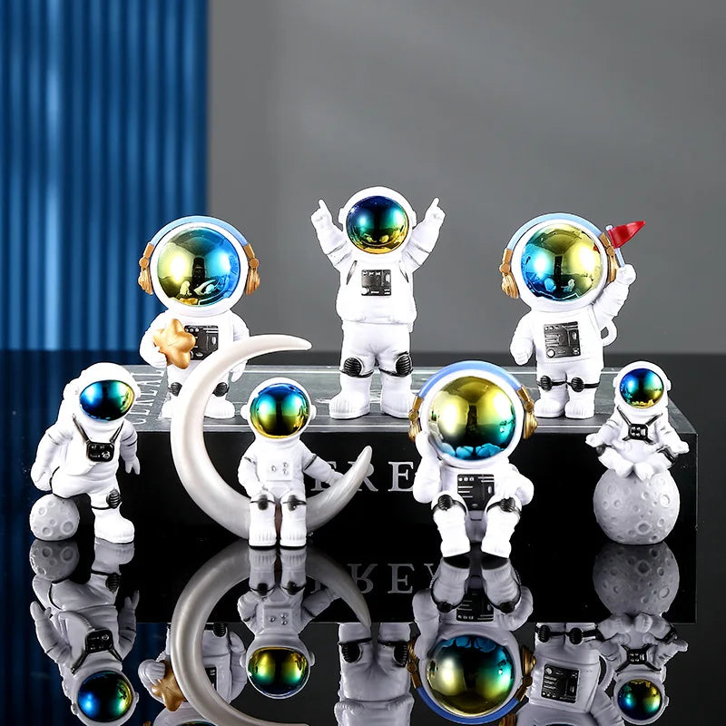 A collection of handcrafted astronaut figurine resin spacemen desk decor displayed on a black surface.