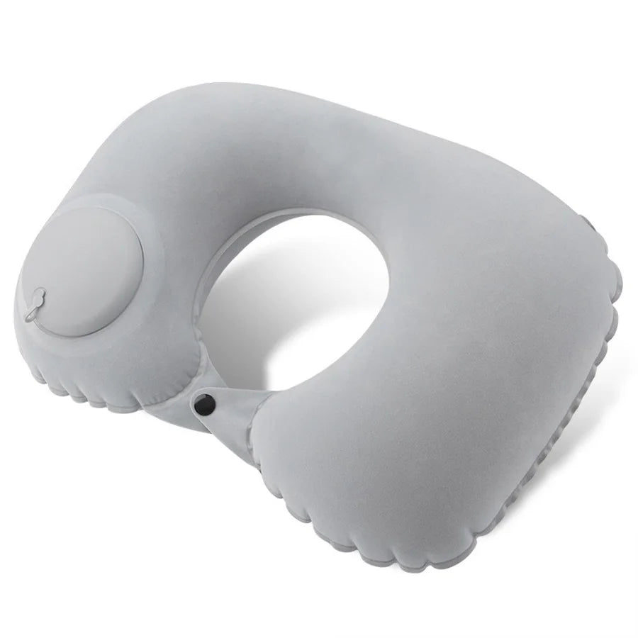 A gray self-inflating travel neck pillow with a soft flocking cover shown from the side.