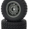 A black RC car receiver parts kit showing a tire and a separate rubber ring.