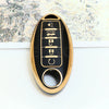 A close-up of a black and gold soft TPU car key fob cover with five buttons for a Nissan vehicle.
