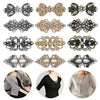 A collection of vintage swirl sweater clips in silver and gold tones for decorating cardigans and shawls.