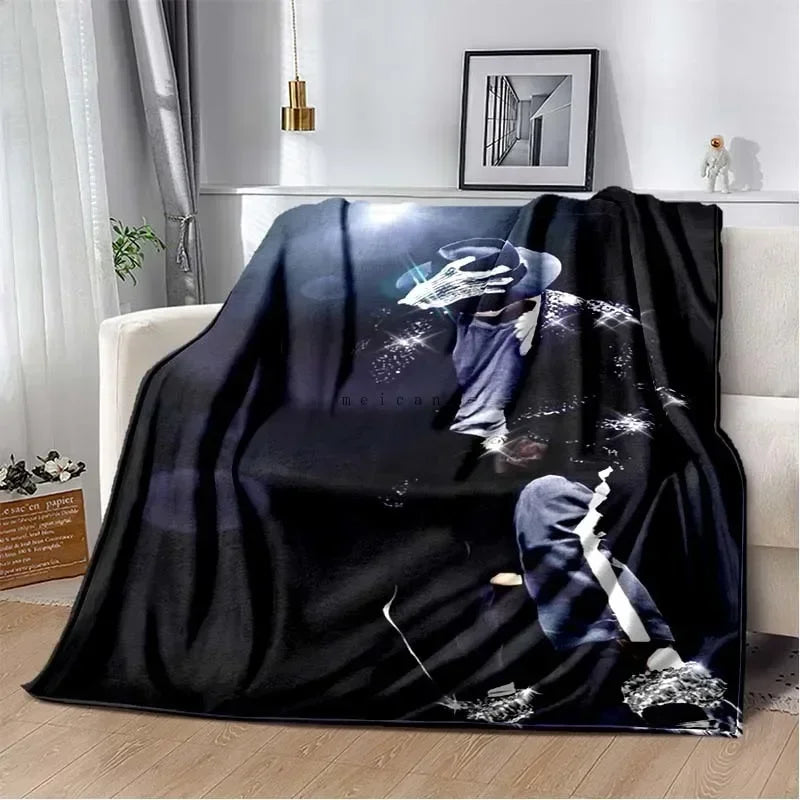 A black flannel throw blanket featuring a print of Michael Jackson's silhouette and stars.