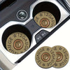 Close-up view of a car cup holder with two absorbent leather mats featuring a star pattern and gauge markings