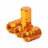 A set of four brass-colored aluminum alloy wheel tire valve caps with a hexagon design.