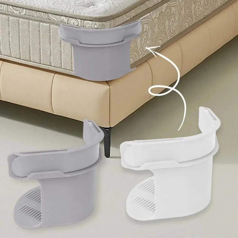 Gray and white clips used to tighten the corner of a mattress or sofa cover.