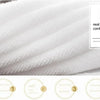 Close-up of a white soft cotton terry cloth face towel showing its texture and loop comfort.