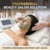 A woman receives a facial treatment with a green mask while a professional applies a black bouffant cap.
