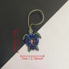 Handcrafted rhinestone bag charms featuring a sparkling blue and green sequin octopus and turtle pendant keychains.