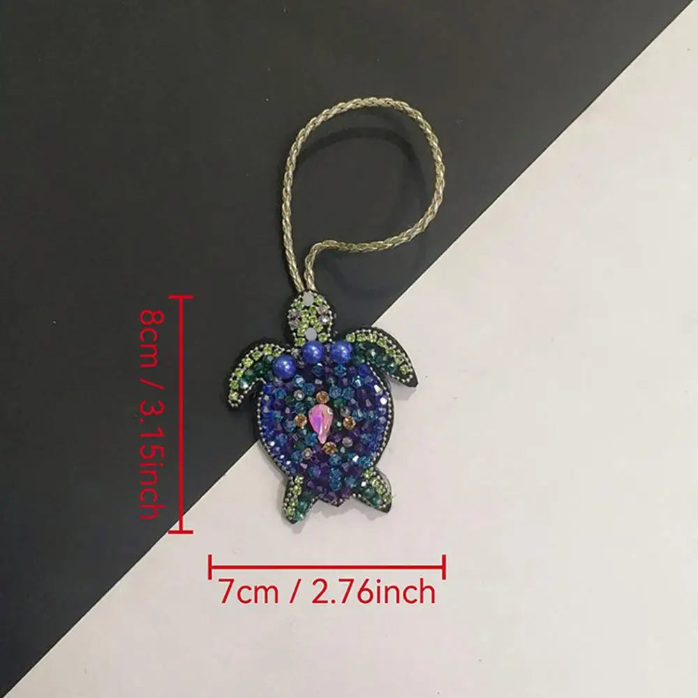 Handcrafted rhinestone bag charms featuring a sparkling blue and green sequin octopus and turtle pendant keychains.