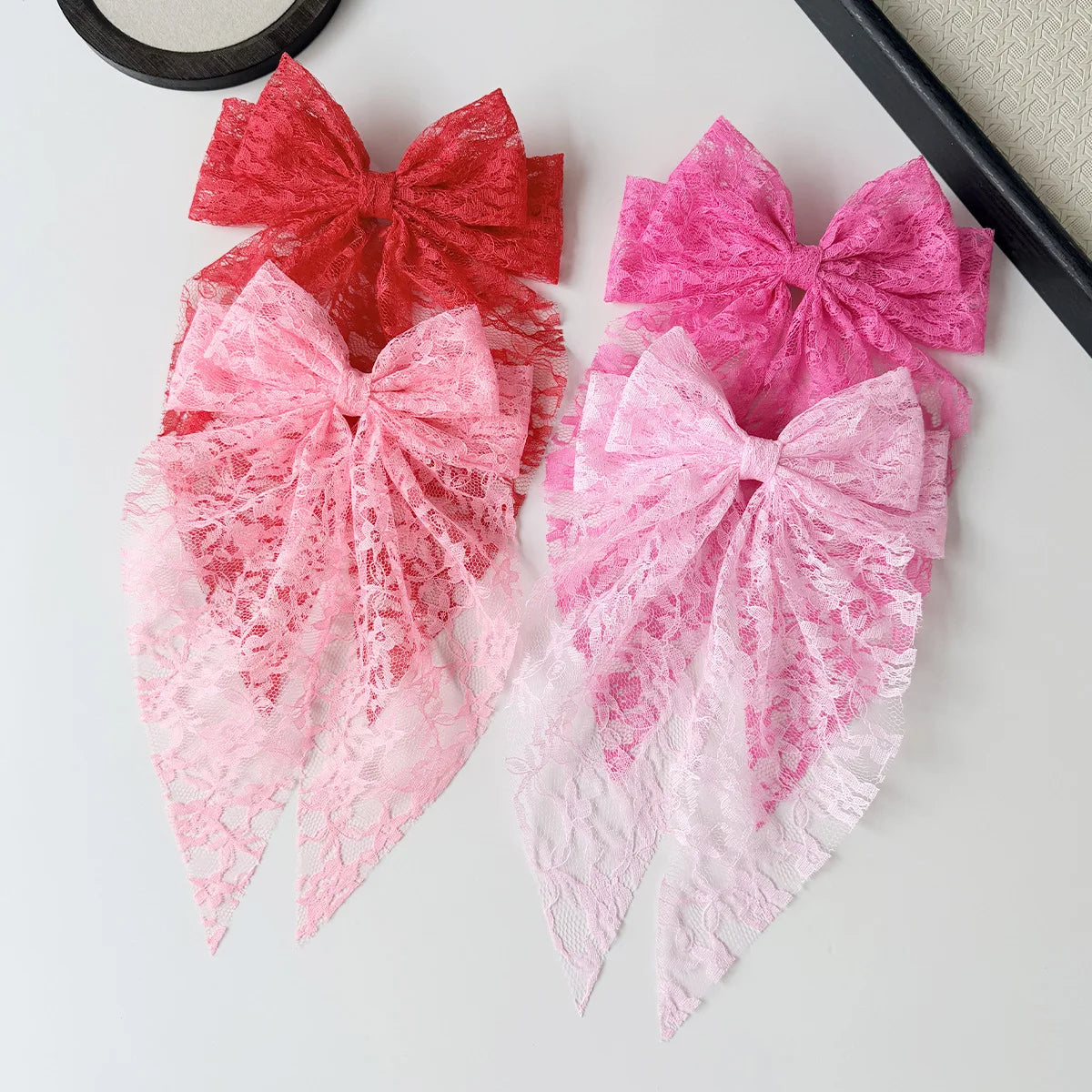 Pink and red lace bows for hair accessories featuring various sizes and styles