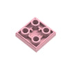 A pink 2x2 reverse light panel for building blocks, featuring four circular light elements.