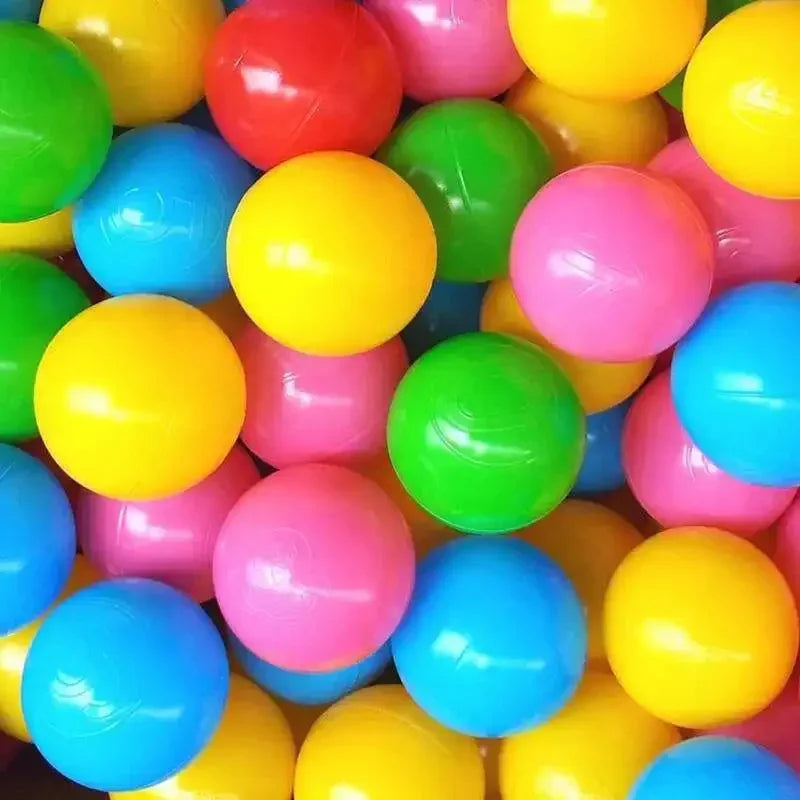 A pile of colorful plastic balls in various shades including yellow, green, pink, and blue.